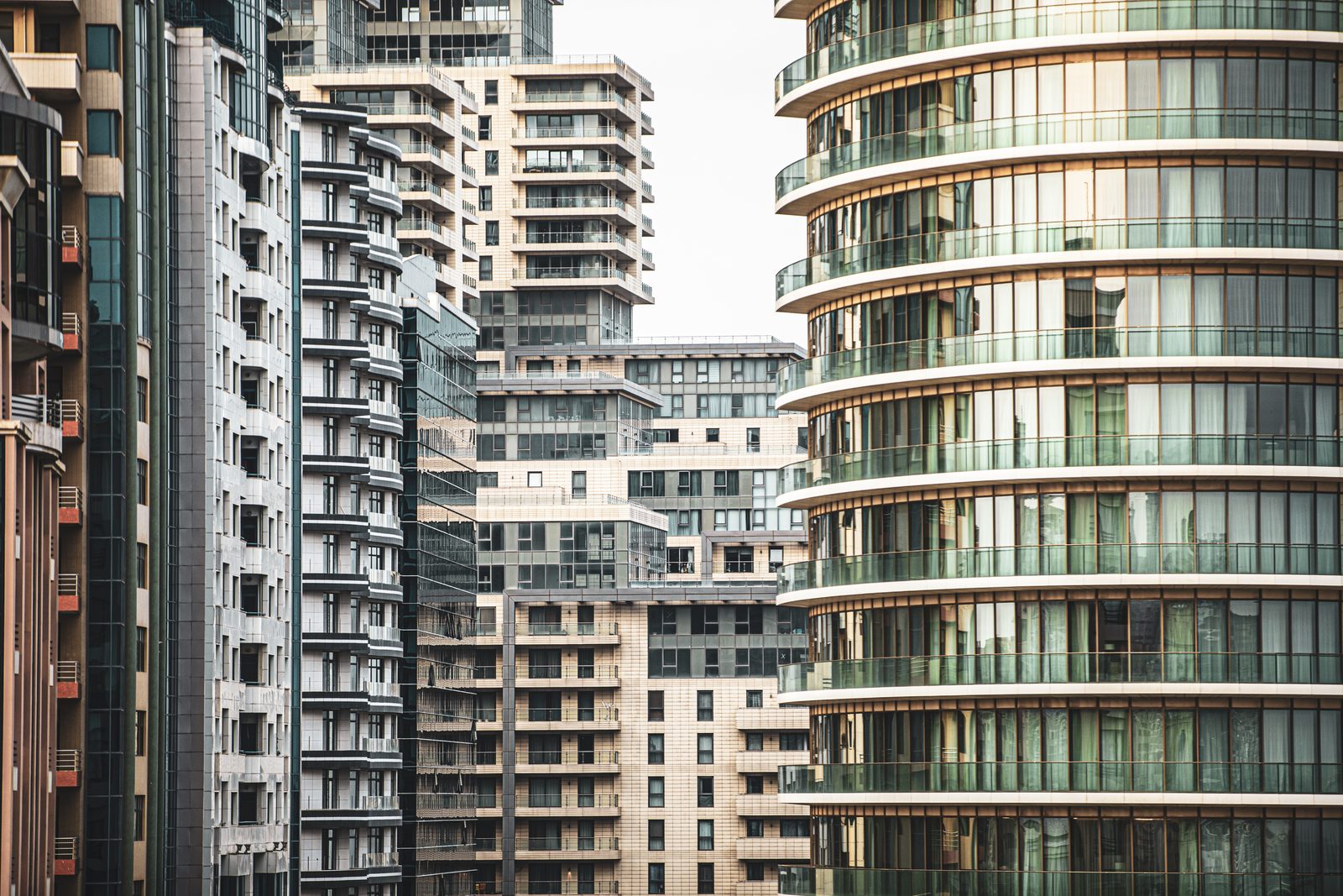 Apartment blocks of different heights and materials packed close together, balconies and windows repeating across every face.